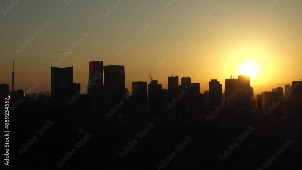 TOKYO, JAPAN - NOV 2023 : Aerial high angle view of cityscape of Tokyo and Mount Fuji in sunset. View of office buildings around Tokyo station and Nagatacho area. 4K time lapse shot, day to night. TOKYO, JAPAN - NOV 2023 : Aerial high angle view of cityscape of Tokyo and Mount Fuji in sunset. View of office buildings around Tokyo station and Nagatacho area. 4K time lapse shot, day to night.