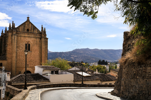 Streets of Ronda city with its historical houses and the Church of The Holy Spirit photo
