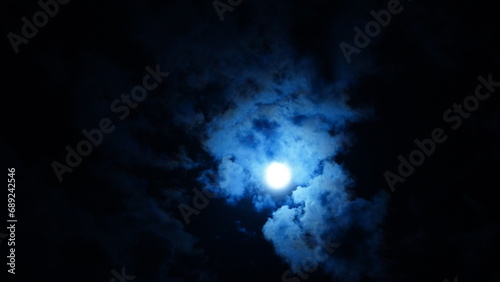 The moon night view with the full moon and clouds in the sky