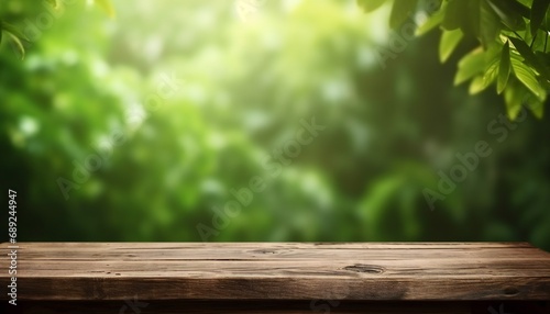 Empty wooden table with blurred green background. wooden desk in garden