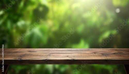 Empty wooden table with blurred green background. wooden desk in garden