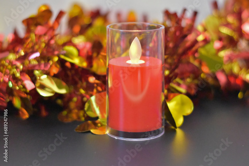 Christmas candles with a Christmas tree in the background