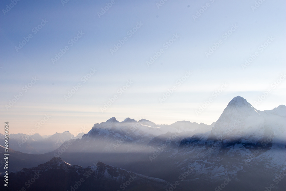 landscape of mountains with snow in the dusty morning and clear sky