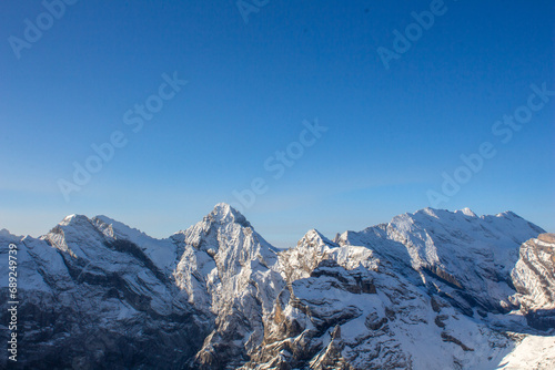 snow covered mountains in winter with clear sky © Indira