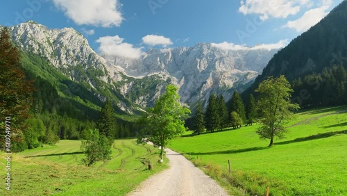 Idyllic green valley with Kamnik-Savinja Alps at background photo