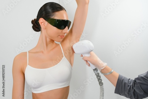 Woman getting laser treatment on her armpit in a beauty salon, close up photo