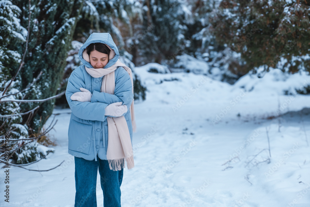 portrait of the woman get frozen outdoors at cold winter day