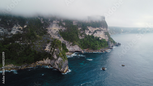 A scenic aerial top view of ocean waves hitting the rocky cliff at Wedding Cake Rock beach in Sydney © fifthplanet