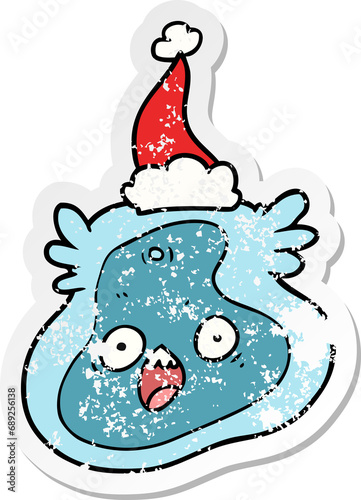hand drawn distressed sticker cartoon of a germ wearing santa hat © lineartestpilot