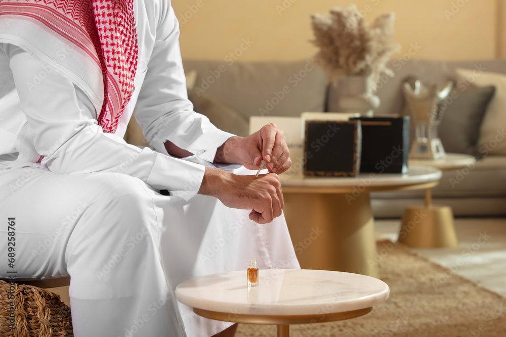 Arab Man testing oud oil on his hand