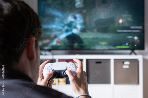 A man playing with a computer game on a big screen.