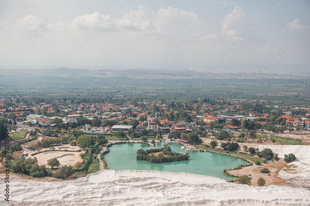 Fototapeta premium Beautiful landscape with calcium travertine terraces, blue pond and sky in Pamukkale, Turkey