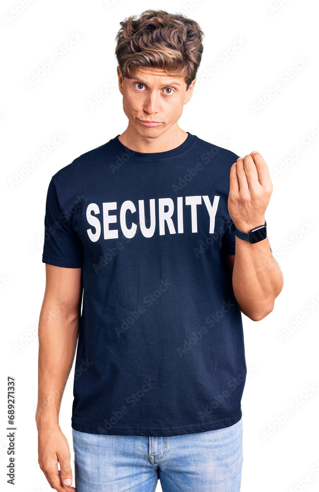 Young handsome man wearing security t shirt doing italian gesture with hand and fingers confident expression Young handsome man wearing security t shirt doing italian gesture with hand and fingers confident expression