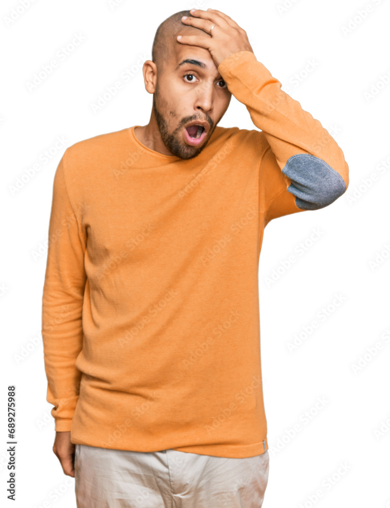 Hispanic adult man wearing casual winter sweater surprised with hand on head for mistake, remember error. forgot, bad memory concept. Hispanic adult man wearing casual winter sweater surprised with hand on head for mistake, remember error. forgot, bad memory concept.