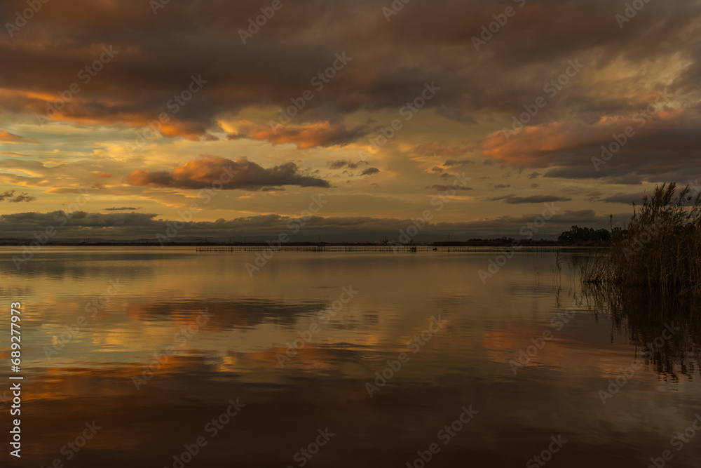Reflecting yellow-red clouds in Lake Albufera