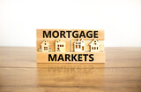 Mortgage markets symbol. Concept words Mortgage markets on beautiful wooden blocks. Beautiful wooden table white background. House model. Business mortgage markets concept. Copy space.