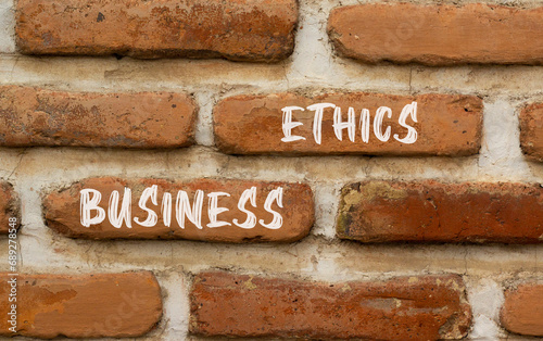 Business ethics symbol. Concept words Business ethics on beautiful brown brick wall. Beautiful brown brick wall background. Business ethics concept. Copy space.
