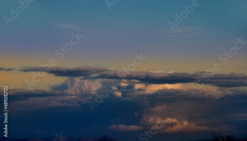 Multicolored sky with gray clouds. Winter weather before the storm. Spring winds scatter the clouds in the blue sky. Peace of nature looking at the sky. 