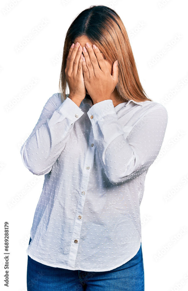 Young hispanic woman wearing casual white shirt with sad expression covering face with hands while crying. depression concept. Young hispanic woman wearing casual white shirt with sad expression covering face with hands while crying. depression concept.