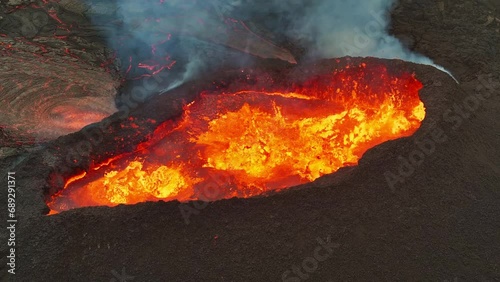 Close up view of active volcanic crater eruption. Hot lava and magma splashing out of crater. Tourist attraction in Iceland Litlihrutur eruption 2023. Beautiful and dangerous disaster. photo
