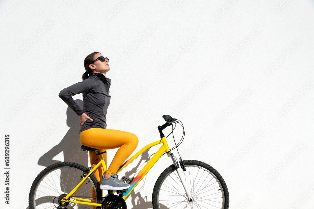 female cyclist with pain in her lower back after riding female cyclist with pain in her lower back after riding