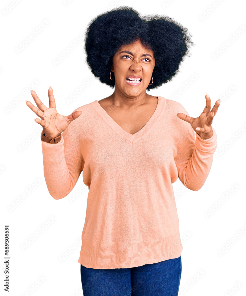 Young african american girl wearing casual clothes crazy and mad shouting and yelling with aggressive expression and arms raised. frustration concept. Young african american girl wearing casual clothes crazy and mad shouting and yelling with aggressive expression and arms raised. frustration concept.