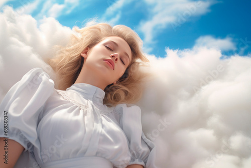 Beautiful young woman blonde is sleeping in sky on clouds. Lush hair accentuates her beauty. Her face is calm and peaceful. She has excellent dreams. The blue sky. Close-up. Copy space.