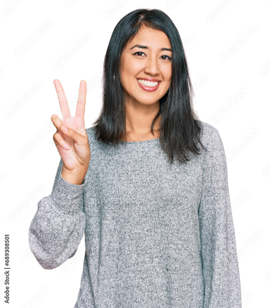 Beautiful asian young woman wearing casual clothes showing and pointing up with fingers number two while smiling confident and happy. Beautiful asian young woman wearing casual clothes showing and pointing up with fingers number two while smiling confident and happy.