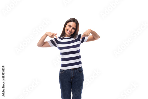 energetic young caucasian brunette woman in a striped t-shirt rejoices on a white background with copy space. advertising concept