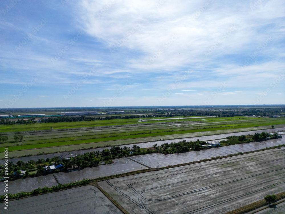 Aerial view the landscape greenfield of a lot of agriculture fields with solar roof top at warehouse. Farming and agriculture industry. urban area of Thailand.