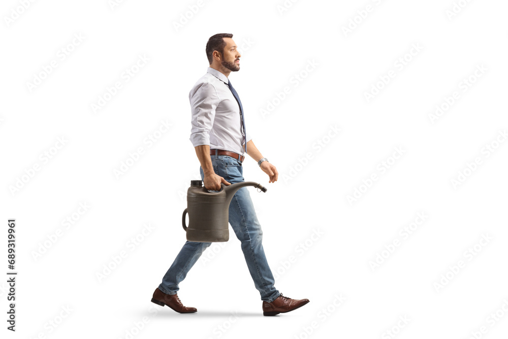 Full length profile shot of a businessman walking with a gas canister Full length profile shot of a businessman walking with a gas canister