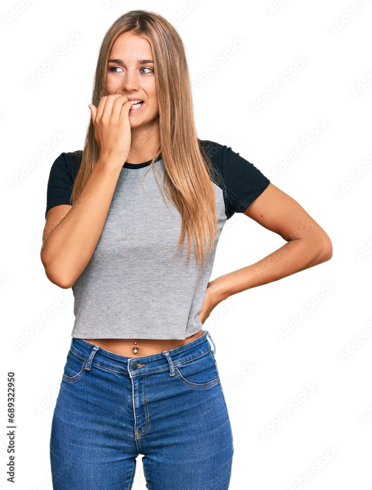 Young blonde woman wearing casual clothes looking stressed and nervous with hands on mouth biting nails. anxiety problem. Young blonde woman wearing casual clothes looking stressed and nervous with hands on mouth biting nails. anxiety problem.