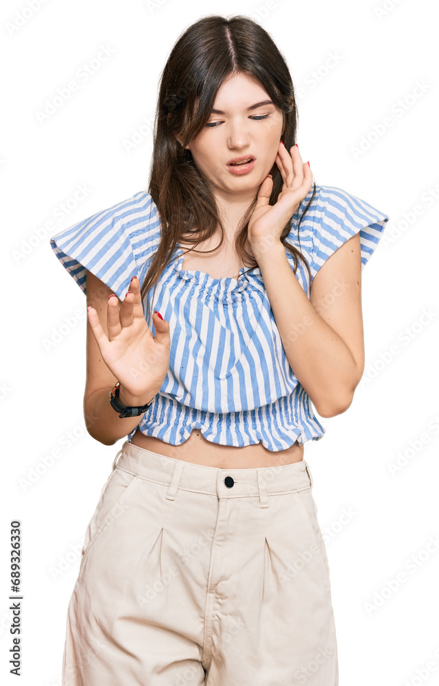Young beautiful caucasian girl wearing casual clothes disgusted expression, displeased and fearful doing disgust face because aversion reaction. Young beautiful caucasian girl wearing casual clothes disgusted expression, displeased and fearful doing disgust face because aversion reaction.
