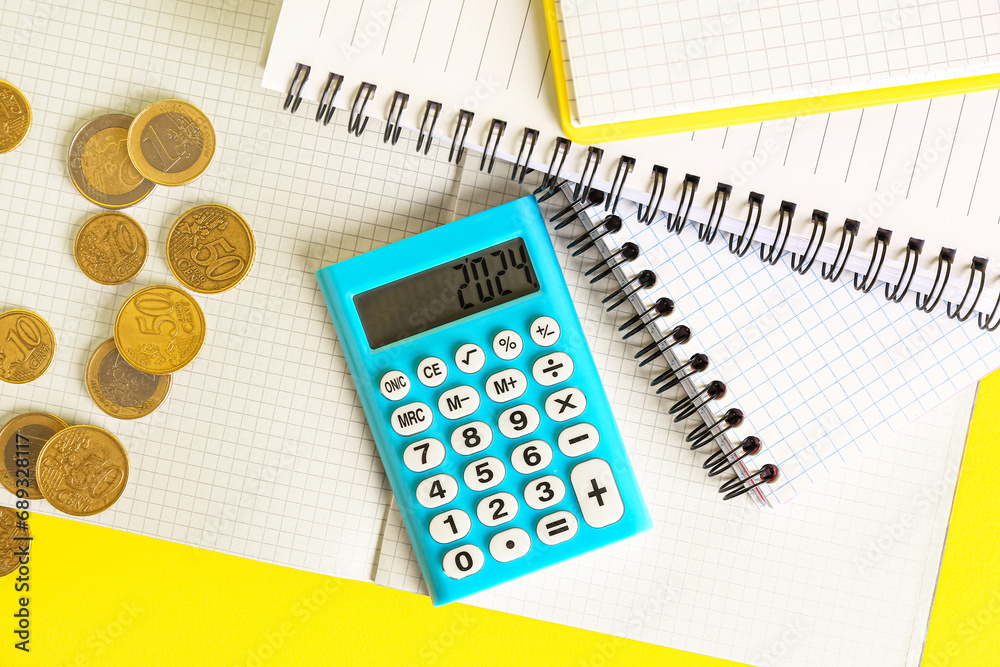 Calculator, notebooks and money on yellow background. Finance concept Calculator, notebooks and money on yellow background. Finance concept