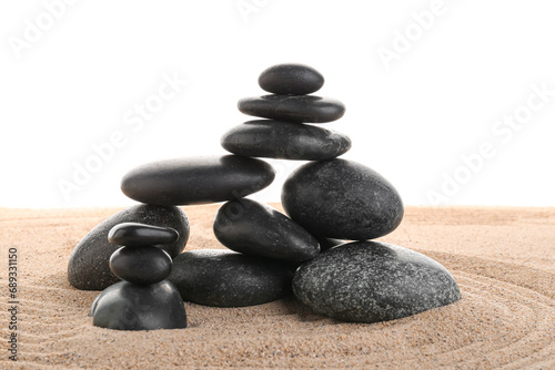 Canvas Print Stack of zen stones on the sand isolated on white background.