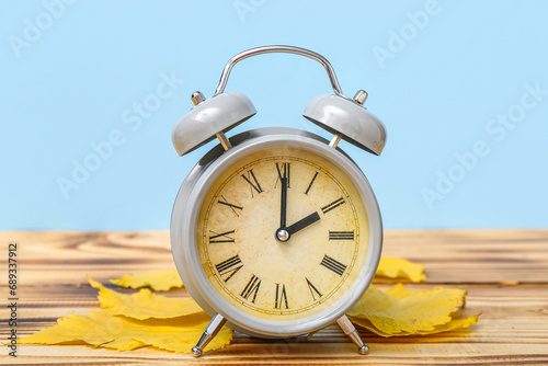 Alarm clock and autumn leav...