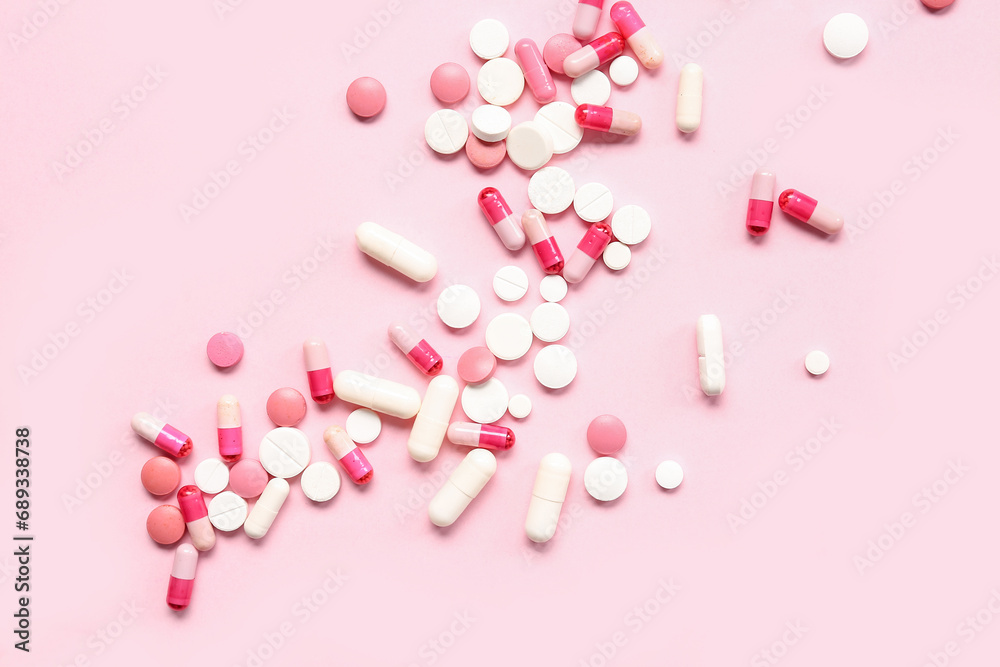 Many different pills on pink background Many different pills on pink background