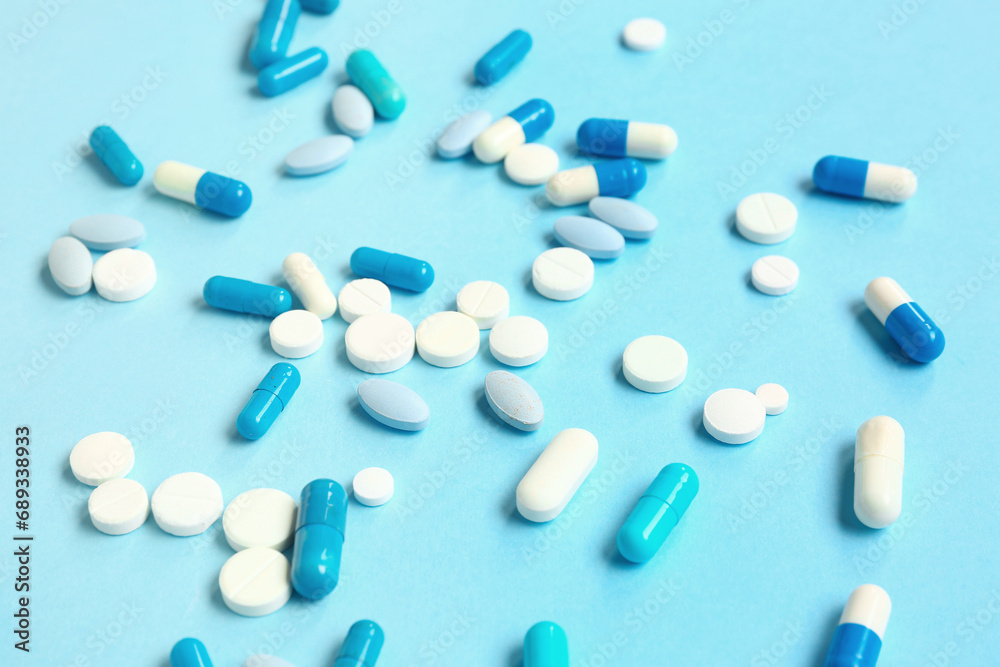 Many different pills on blue background Many different pills on blue background