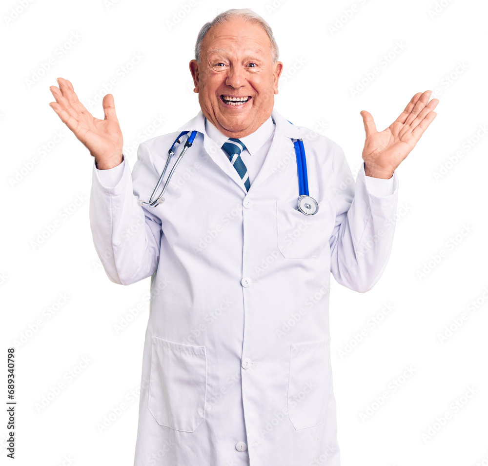 Senior handsome grey-haired man wearing doctor coat and stethoscope celebrating crazy and amazed for success with arms raised and open eyes screaming excited. winner concept Senior handsome grey-haired man wearing doctor coat and stethoscope celebrating crazy and amazed for success with arms raised and open eyes screaming excited. winner concept