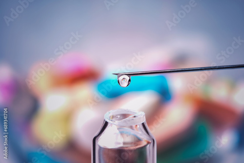 Liquid drop on the tip of a medical needle , bright colorful background , macro photography , medical concept , medical concept