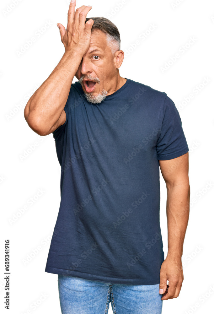 Middle age grey-haired man wearing casual clothes surprised with hand on head for mistake, remember error. forgot, bad memory concept. Middle age grey-haired man wearing casual clothes surprised with hand on head for mistake, remember error. forgot, bad memory concept.