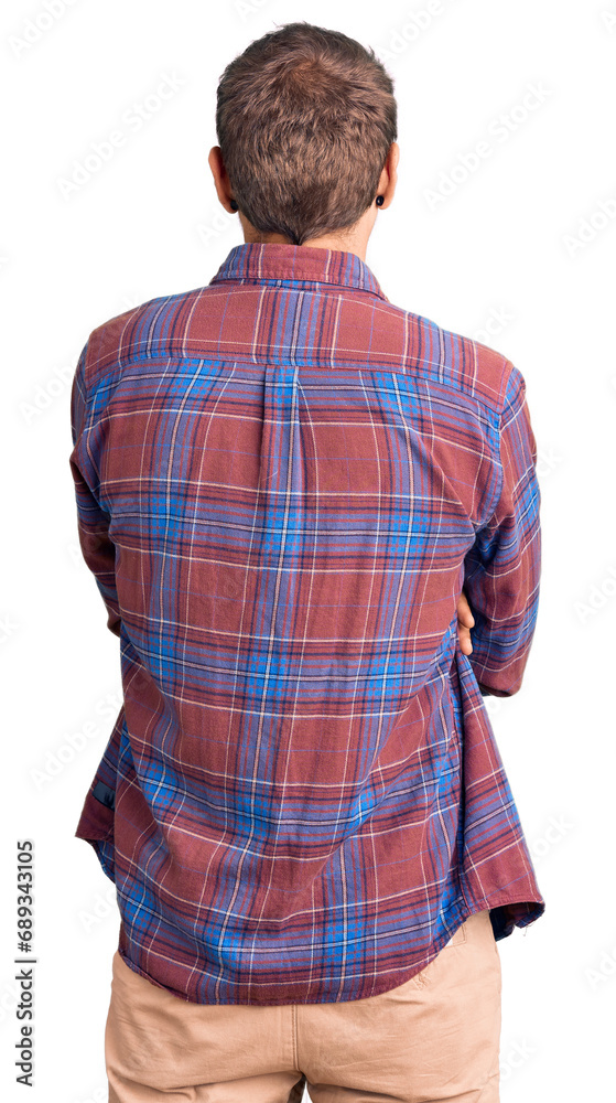Young handsome man wearing casual clothes standing backwards looking away with crossed arms