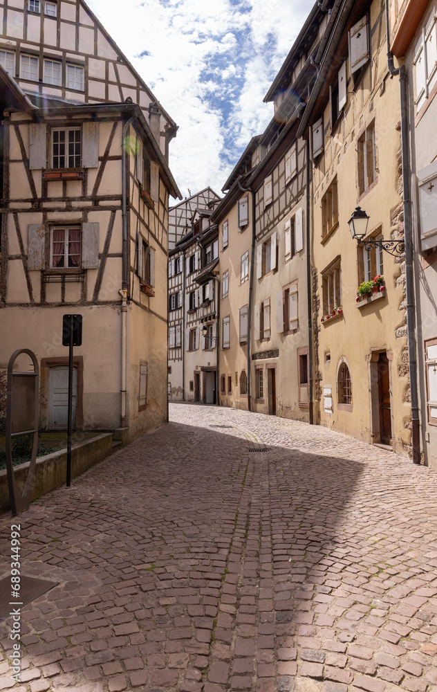 Colmar with a typical, old street with half-timbered houses and cobblestones