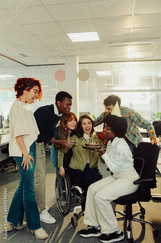 A diverse multiracial colleagues having a birthday party at the office.