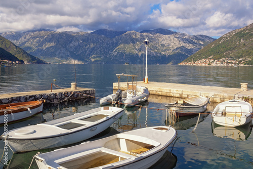 Beautiful autumn Mediterranean landscape. Montenegro  Adriatic Sea  Bay of Kotor. Fishing boats in the small harbor near seaside Stoliv village