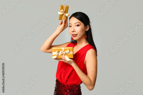Smiling asian woman in red ...