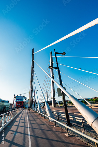 Bicycle Lane on a Big Suspension Bridge in the City Over a River photo