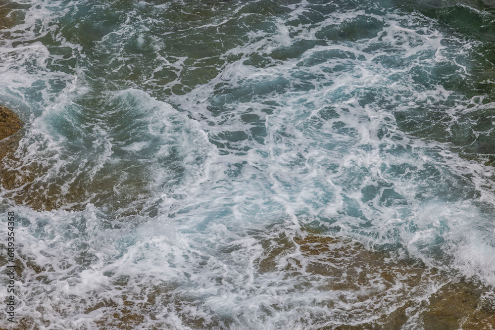 Background, texture showcasing appearance of frothy waters along Atlantic coastline.
