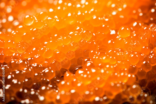 Closeup of natural red caviar as background  texture of expensive luxury fresh orange caviar macro photo