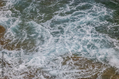 Background, texture showcasing appearance of frothy waters along Atlantic coastline. © Alex